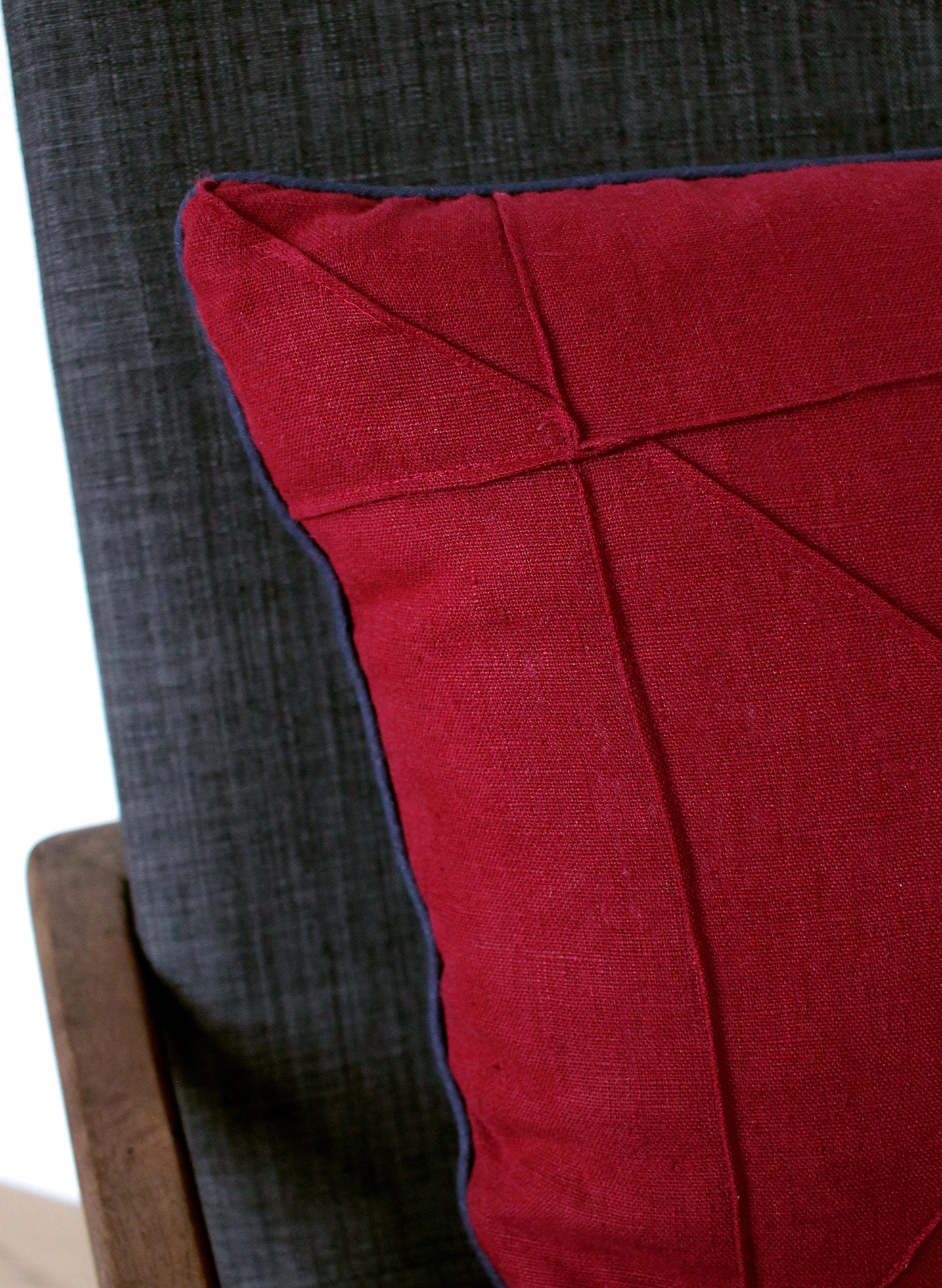 Detail of origami stitching on cranberry linen cushion cover