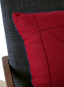 Detail of origami stitching on cranberry linen cushion cover