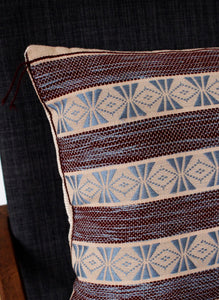 Corner detail of maroon pattern handwoven cushion